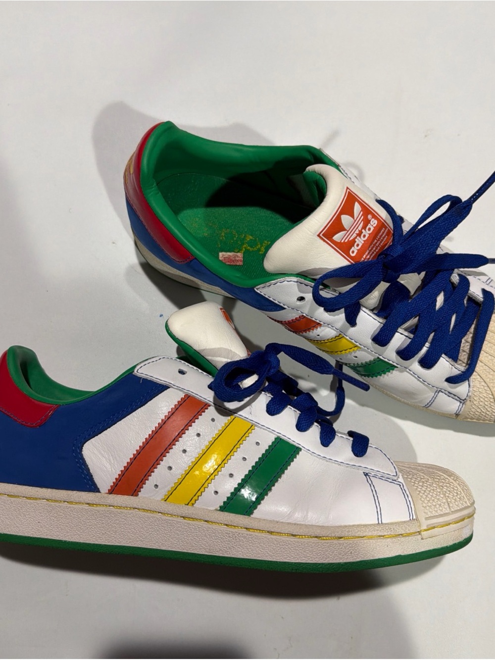 adidas White Leather Sneakers with Rainbow Stripe Accents and Blue Laces